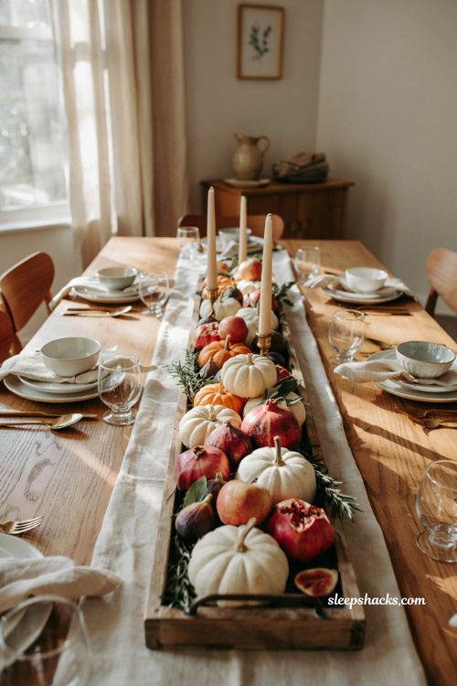Pumpkin baby shower centerpiece with autumn fruit pomegranates figs and apples