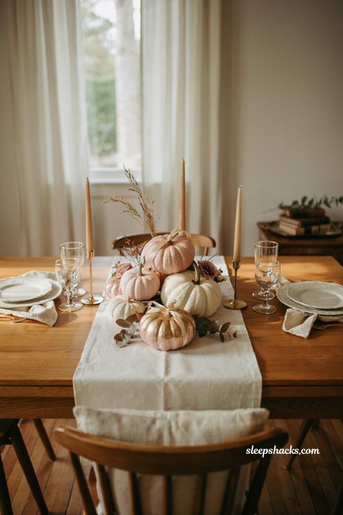 Pumpkin baby shower centerpiece with blush pink pumpkins and gold accents