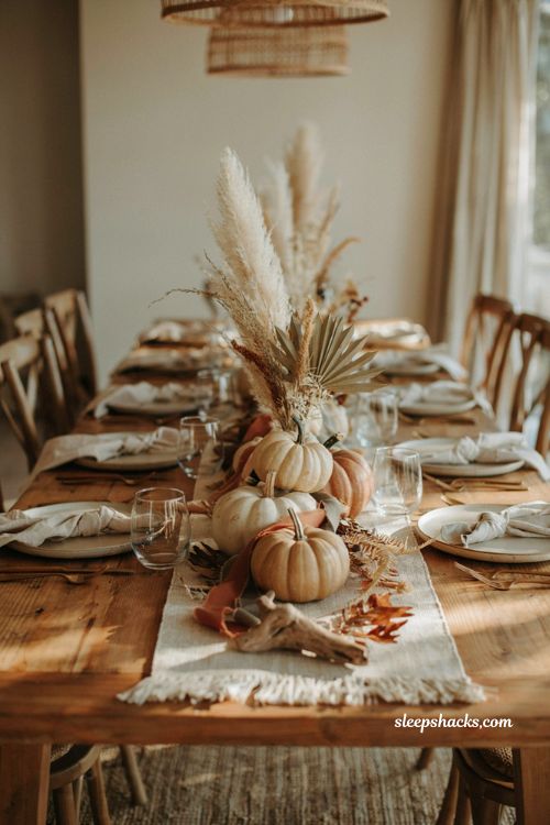 Pumpkin baby shower centerpiece with boho pumpkins pampas grass and dried palms