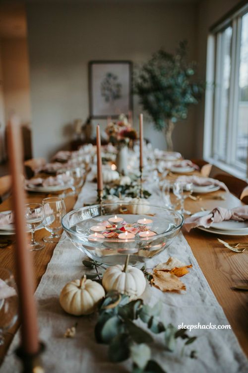 Pumpkin baby shower centerpiece with floating candles glass bowl and greenery