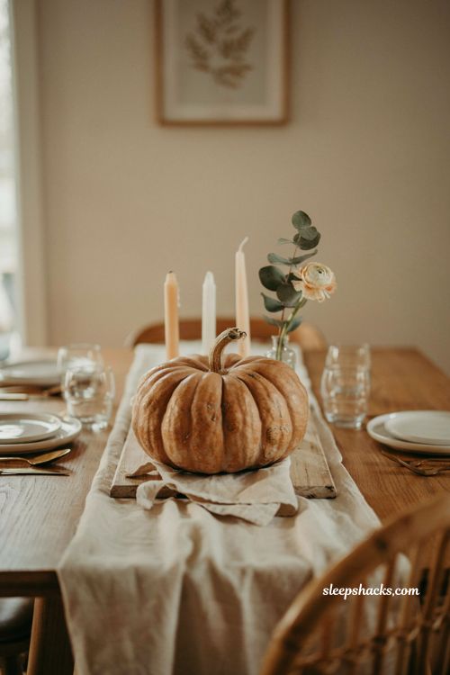 Pumpkin baby shower centerpiece with single statement pumpkin and candles