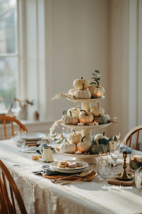 Pumpkin baby shower centerpiece with tiered cake stand pumpkins and candles