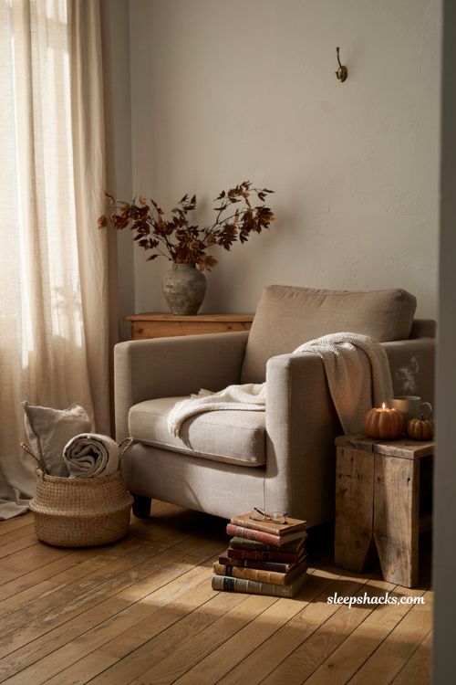 Pumpkin candle cozy fall living room decor with warm autumn light and modern farmhouse styling