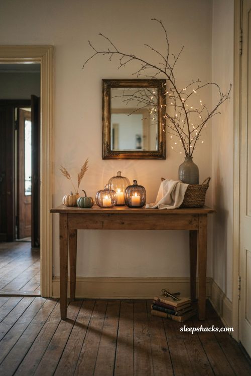 Pumpkin candles and twinkle branches Halloween console table decor