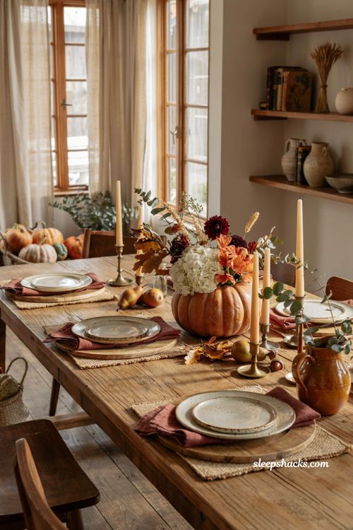 Pumpkin centerpieces fall dining table with fresh flowers and cozy farmhouse styling
