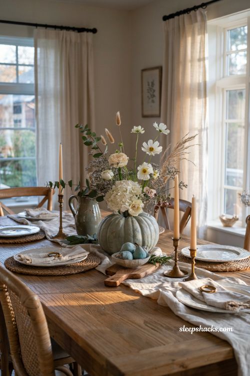 Pumpkin centerpieces fall with a pale blue pumpkin and elegant white floral arrangement
