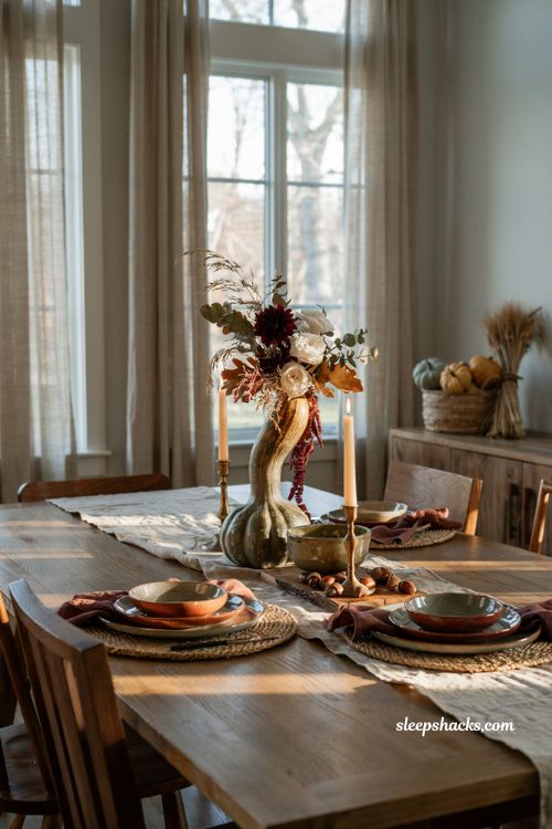 Pumpkin centerpieces fall with a unique heirloom gourd and cascading autumn flowers