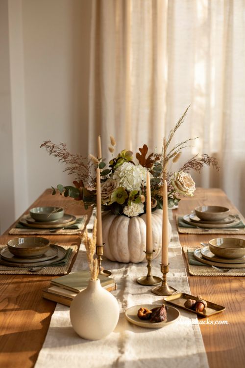 Pumpkin centerpieces fall with a white pumpkin and soft neutral floral arrangement