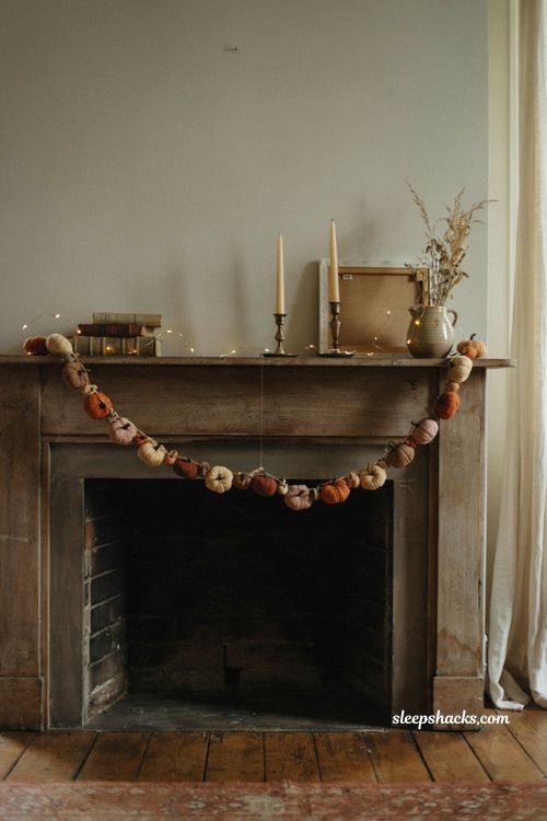 Pumpkin garland across mantel for cozy fall living room decor