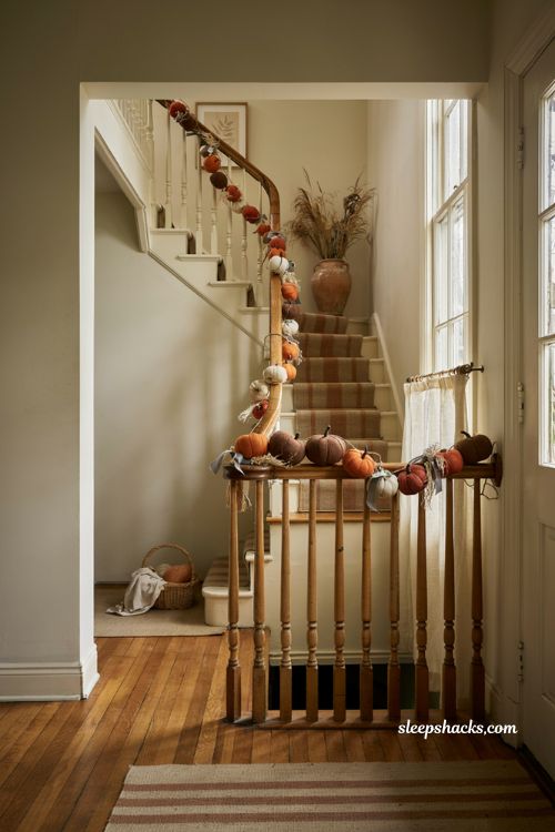 Pumpkin garland along staircase railing for fall decor