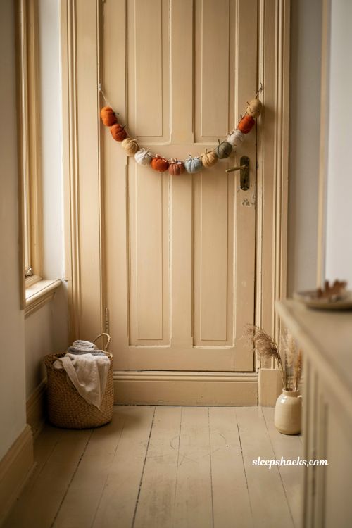 Pumpkin garland on door handle for easy fall decor