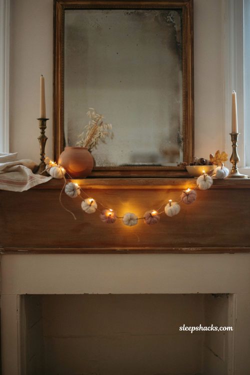 Pumpkin garland with fairy lights for cozy fall mantel decor