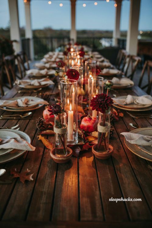 Romantic evening fall baby shower centerpiece with dahlia flowers tied to glass candle votive cylinders