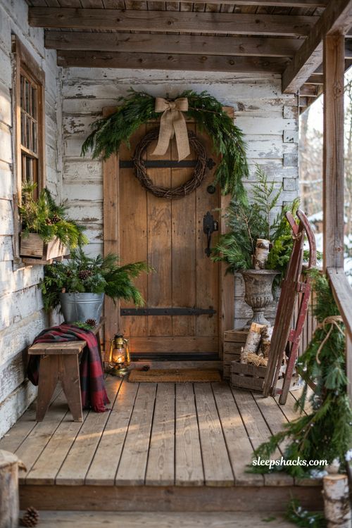Rustic christmas front porch with fresh evergreen garlands and cozy mountain cabin holiday decor
