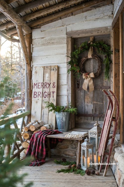 Rustic christmas front porch with handcrafted reclaimed wood sign and farmhouse holiday decor
