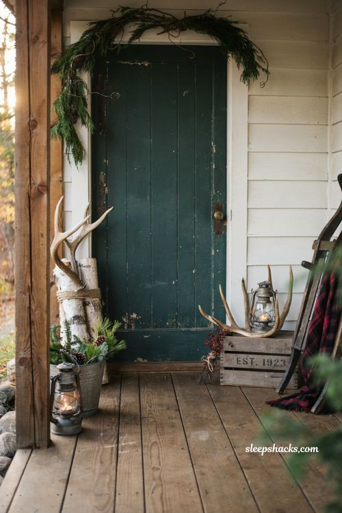 Rustic christmas front porch with natural antlers and cozy mountain cabin holiday decor