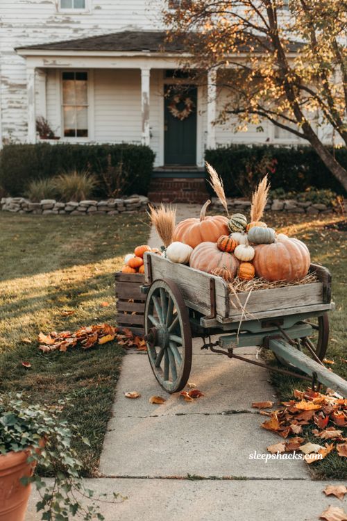 Rustic wagon fall yard display with pumpkins gourds straw dried grasses and cozy farmhouse autumn decor 