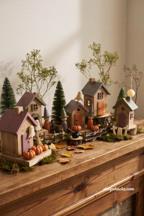 Scrap wood Halloween village with handmade peg doll witches and ghosts 