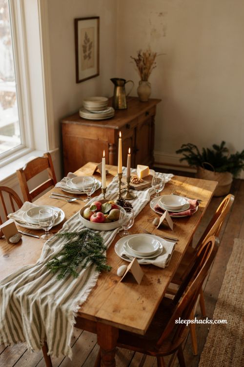 Simple Christmas tablescape ideas with mismatched plates fruit greenery and candles