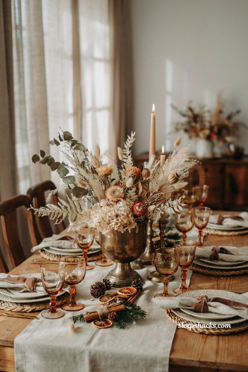 Simple christmas centerpieces for table with dried flowers in a vintage brass compote