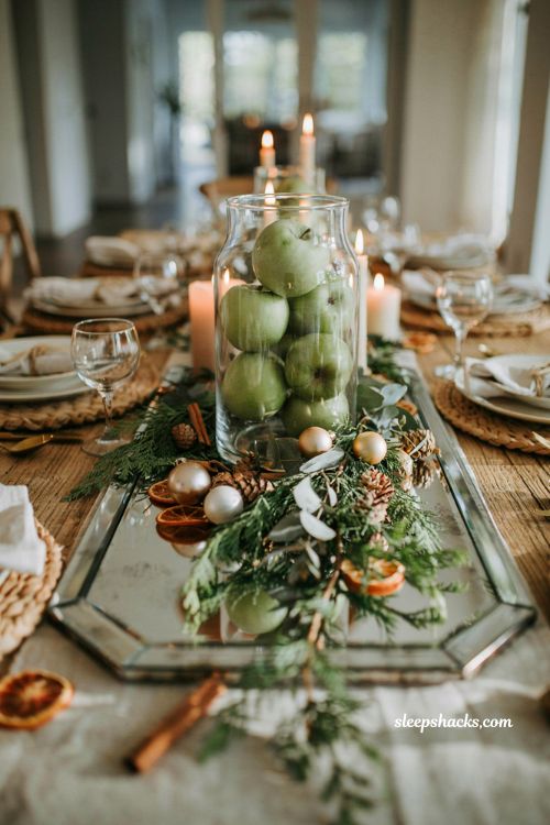 Simple christmas centerpieces for table with green apples in a glass jar and holiday greenery