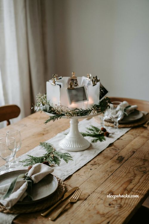 Simple christmas centerpieces for table with sentimental photo display and evergreen accents