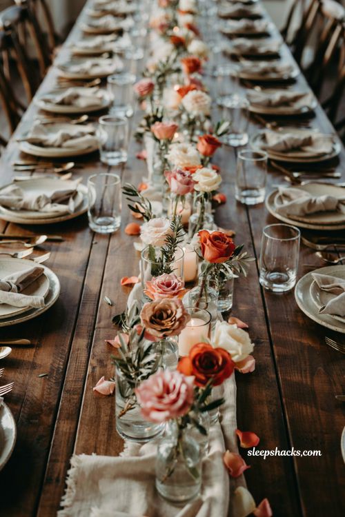 Simple fall baby shower table centerpiece idea with single rose blooms in glass votive holders