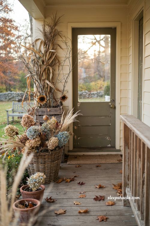 Simple fall front porch ideas with natural yard branches cornstalks hydrangeas and gourds 