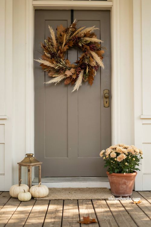 Simple fall front porch ideas with statement wreath focal point and cozy neutral accents 