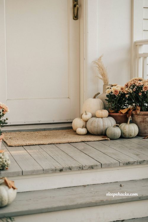 Simple fall front porch ideas with white pumpkins and cohesive neutral color palette 