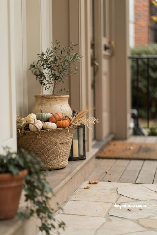 Simple fall front porch ideas with woven basket mini pumpkins and rustic autumn decor 