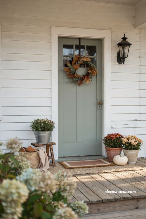 Simple fall front porch ideas with wreath mums and cozy neutral rug 