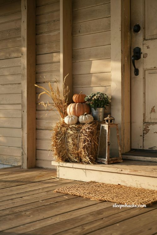 Simple small front porch fall decor with a mini hay bale and pumpkins