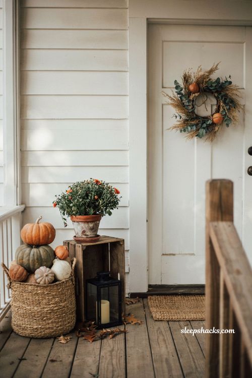 Simple small front porch fall decor with baskets crates and pumpkins