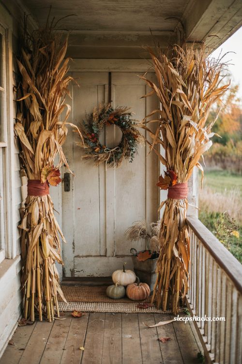 Simple small front porch fall decor with corn stalks and autumn leaves