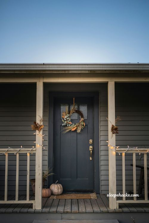 Simple small front porch fall decor with warm white string lights
