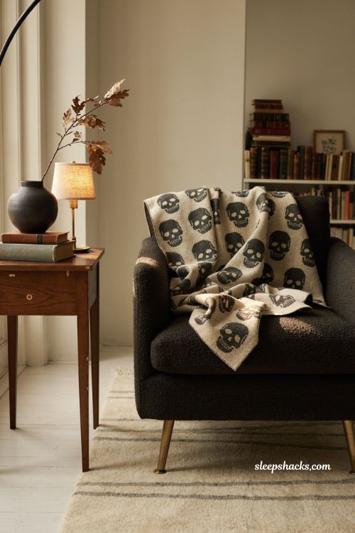 Skull pattern Halloween blanket draped over armchair gothic decor 