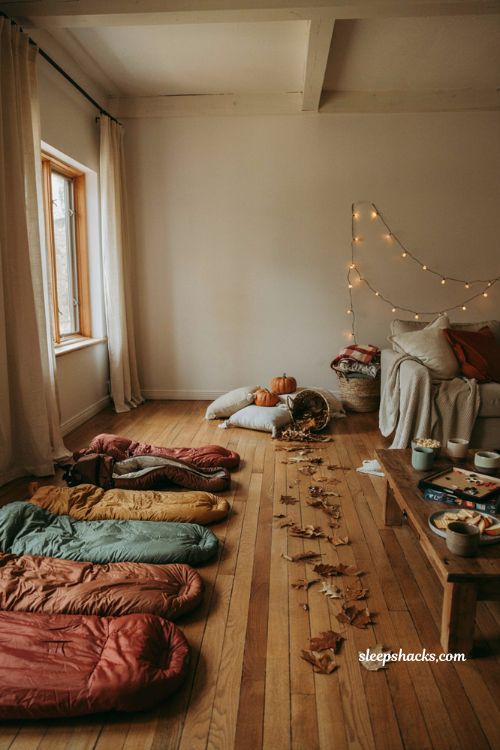 Sleeping bag races for fun fall sleepover ideas with cozy indoor decor 