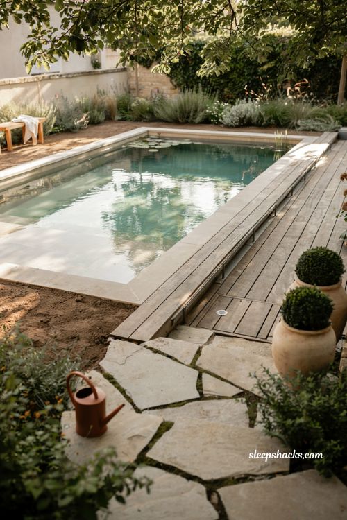 Small natural pool with hidden filtration and a compact eco friendly backyard design