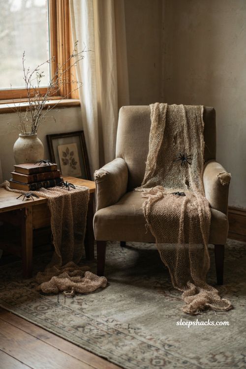 Spooky gauze fabric drape with plastic spiders for a cozy haunted house look 