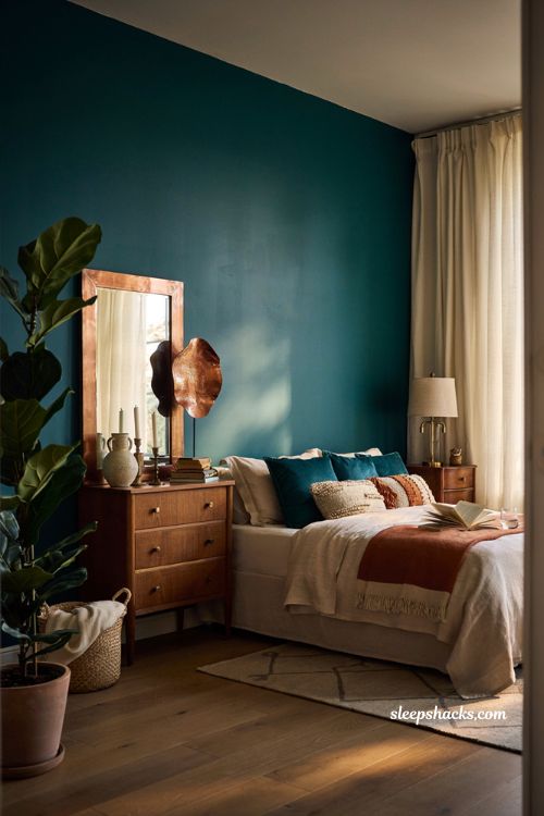 Teal and copper bedroom with copper mirror and metallic wall decor