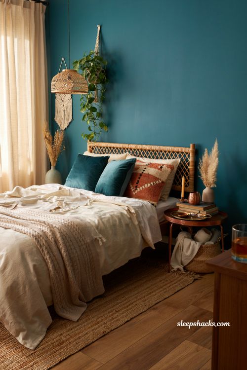 Teal and copper boho bedroom with rattan textures and jute rug