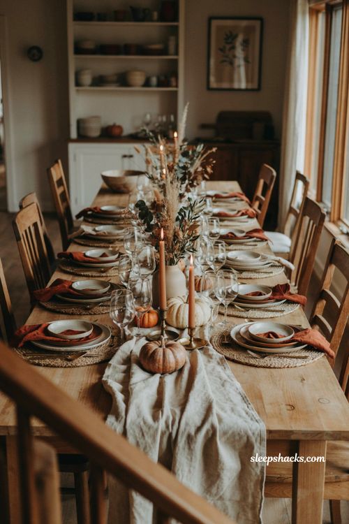 Thanksgiving dinner table setting with cozy farmhouse centerpiece and autumn place settings