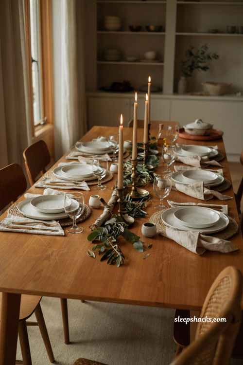 Thanksgiving table setup ideas with white plates greenery candlesticks and reusable holiday decor