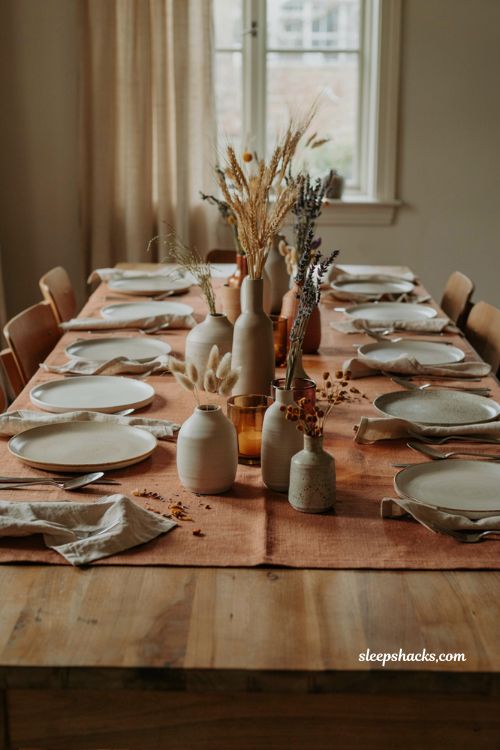 Thanksgiving tablescapes with dried flower arrangements and stoneware vases 