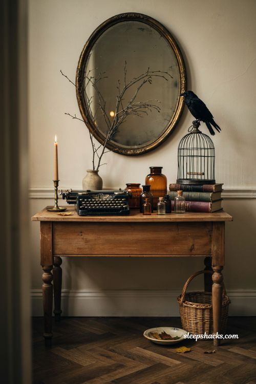 Thrifted vintage Halloween vignette with typewriter birdcage apothecary jars and books