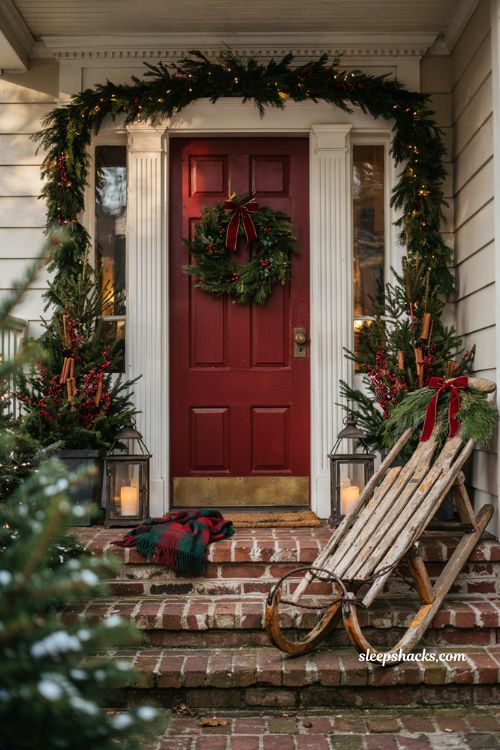 Traditional christmas porch decor with antique sled and classic holiday greenery