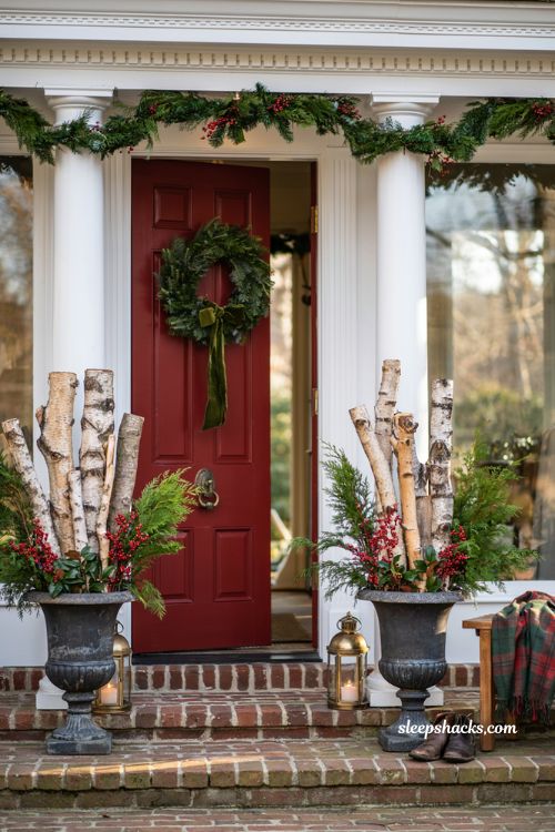 Traditional christmas porch decor with birch logs berries and elegant urn planters