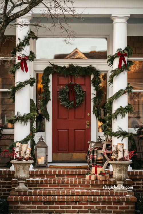 Traditional christmas porch decor with garland wrapped columns and classic holiday greenery