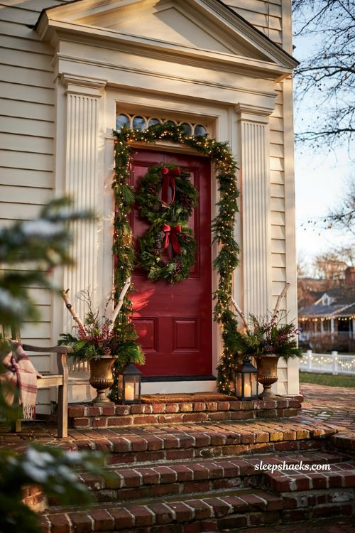 Traditional christmas porch decor with layered wreaths on a large front door